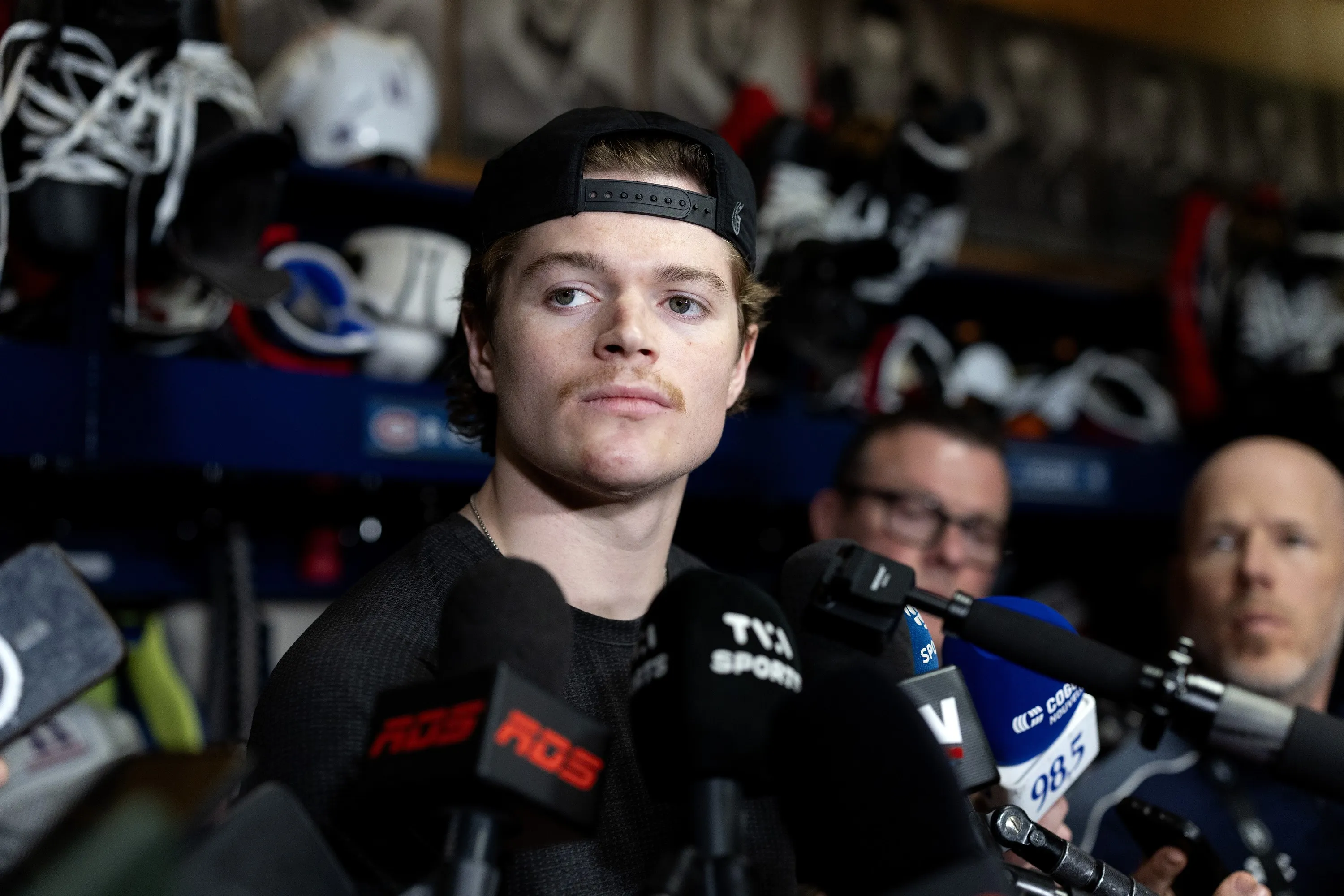Cole Caufield speaking to reporters in the Montreal Canadiens locker room