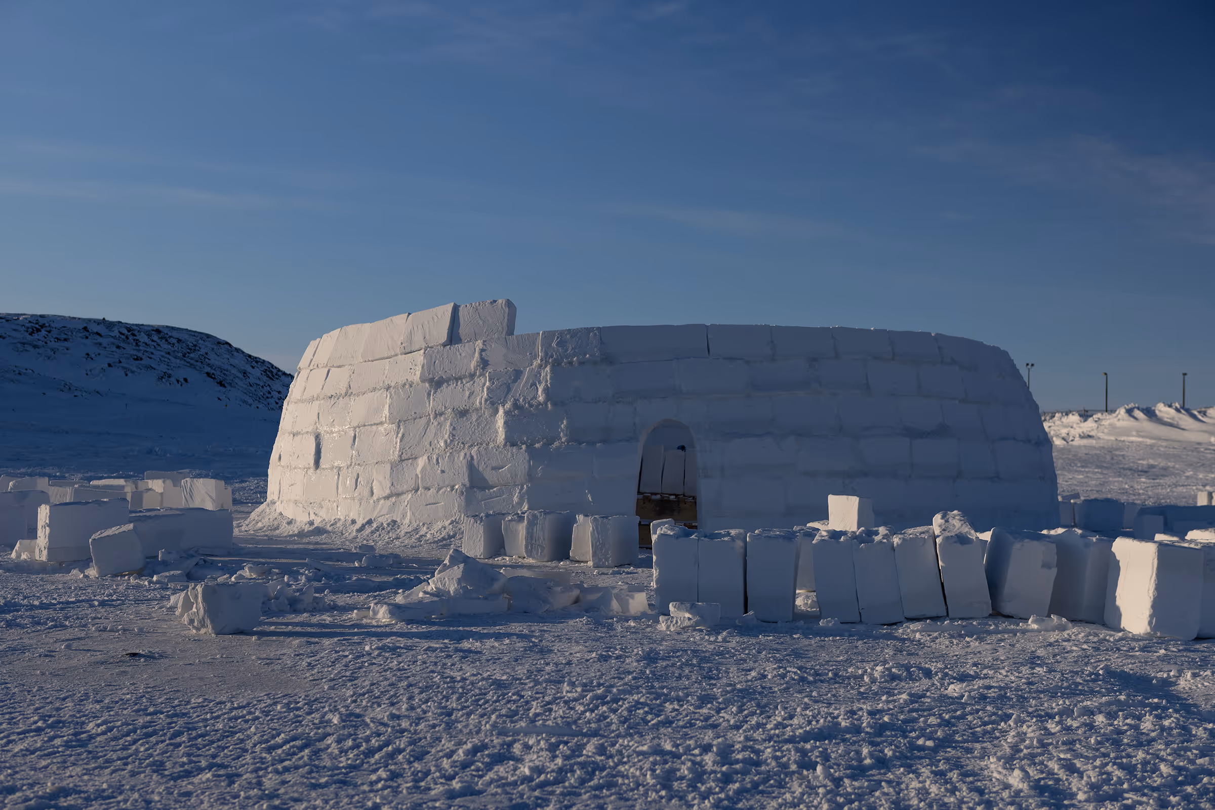 Two men doing construction work on a small wooden frame.