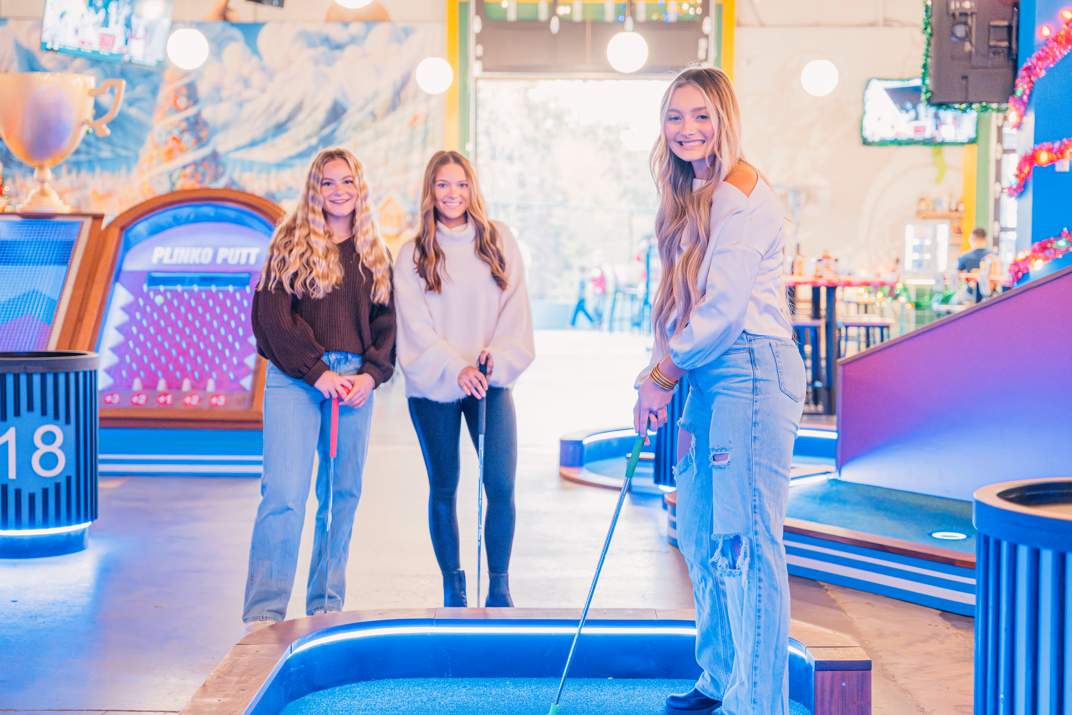 Girls playing minigolf