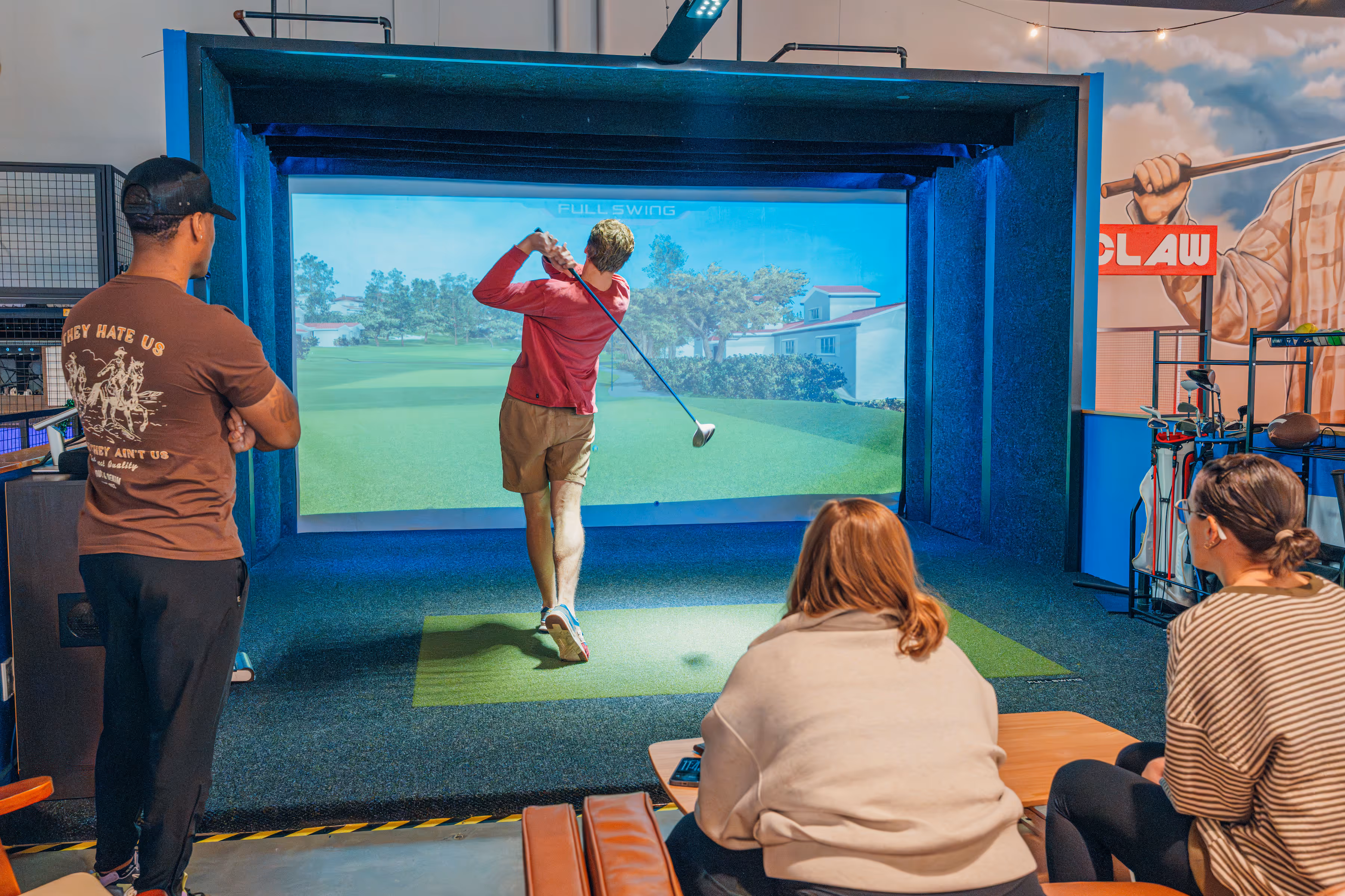 Man golfing in a golf simulator