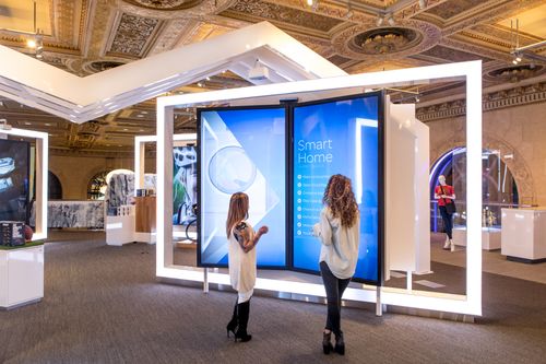 Two women standing in front of 2 LED kiosks in the AT&T flagship store in San Francisco