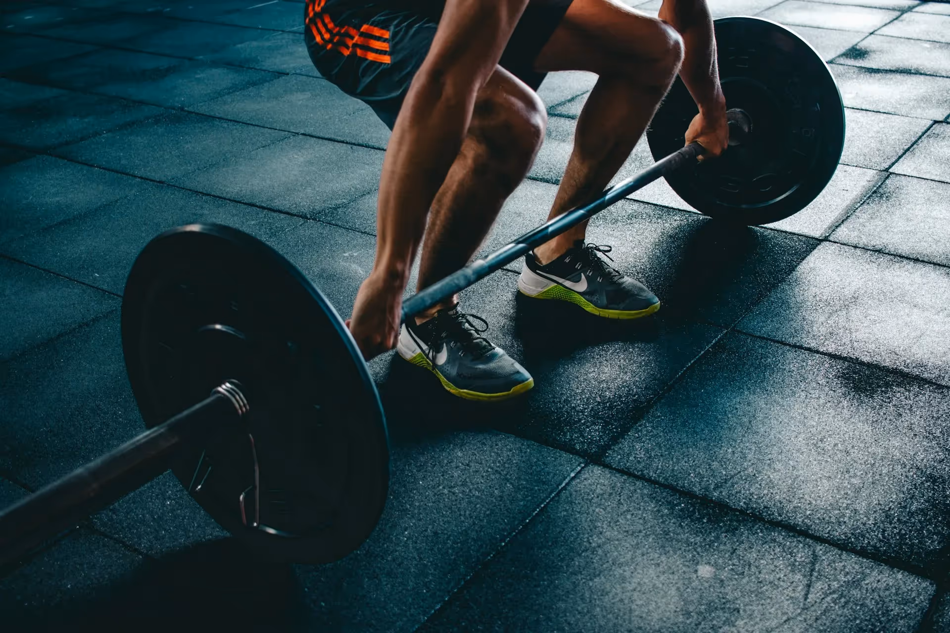 A man lifting weights in a gym.