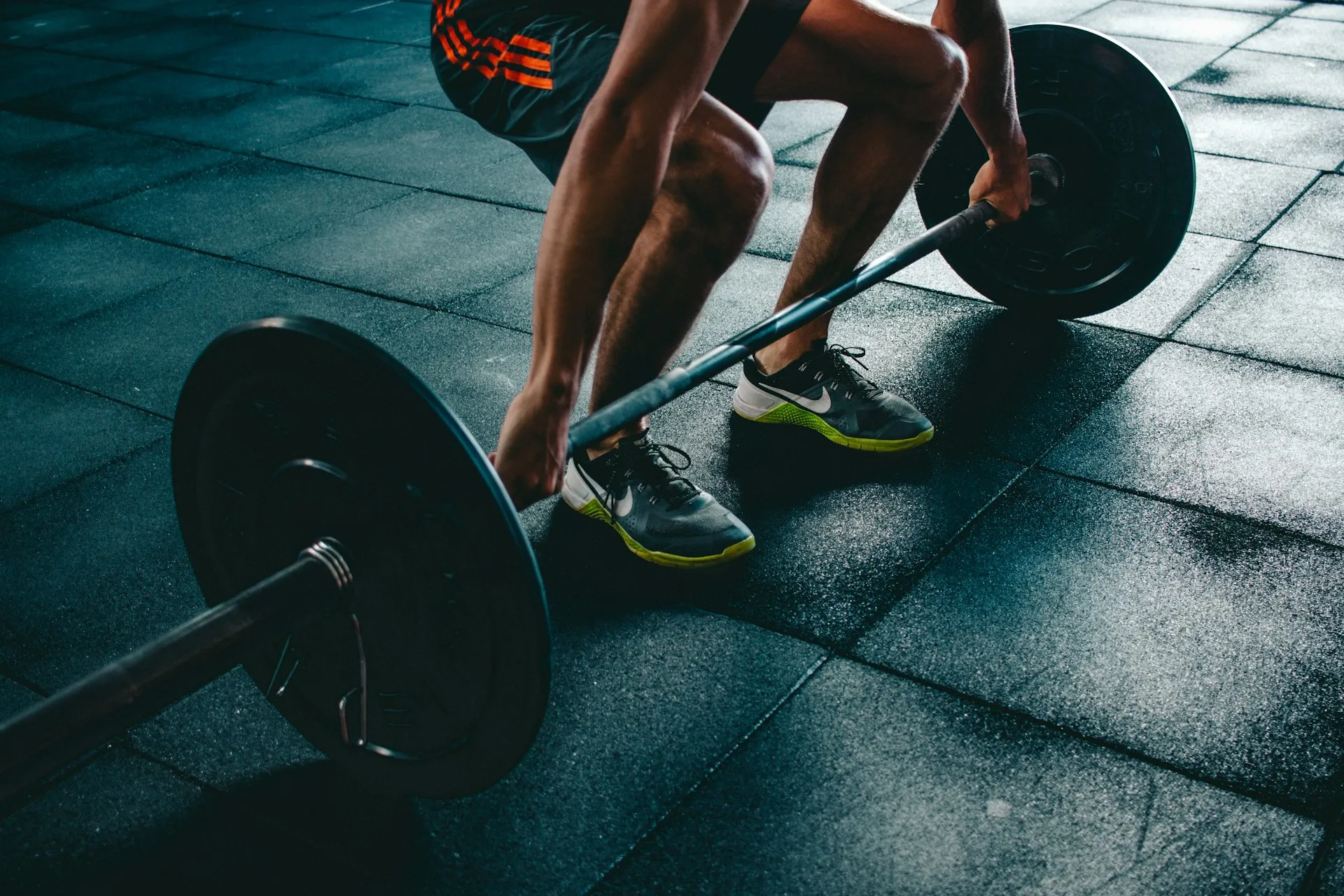 A man lifting weights in a gym.