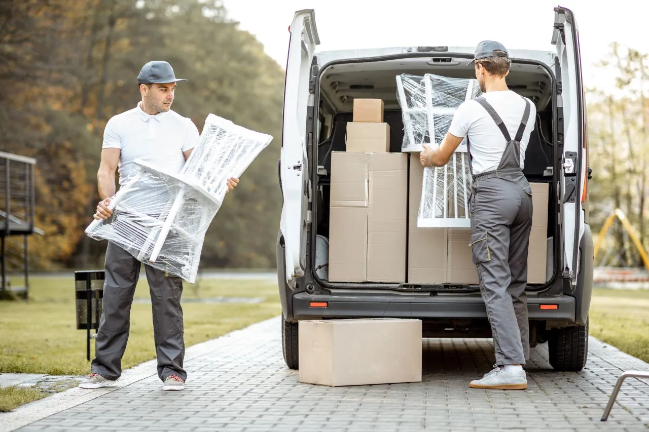 Household items being packed into labeled cardboard moving boxes