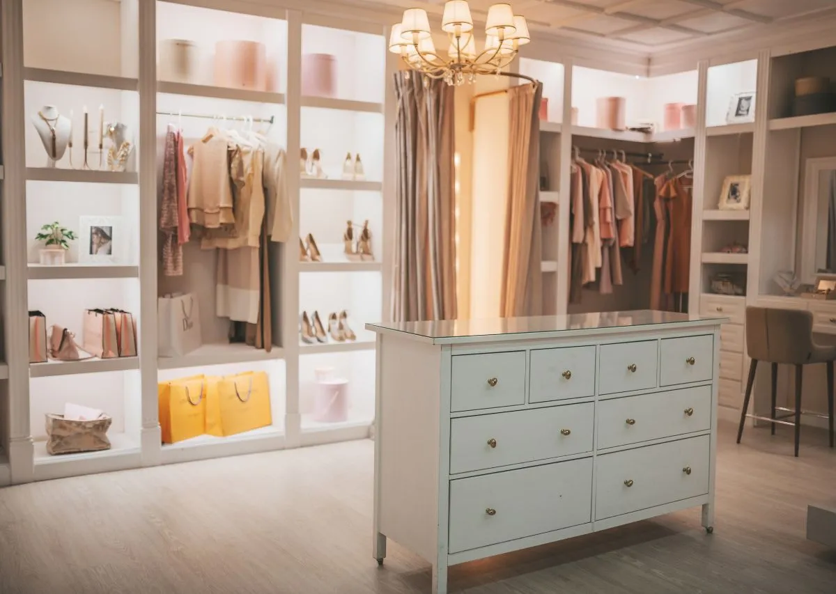 Organized closet with hanging clothes and storage bins