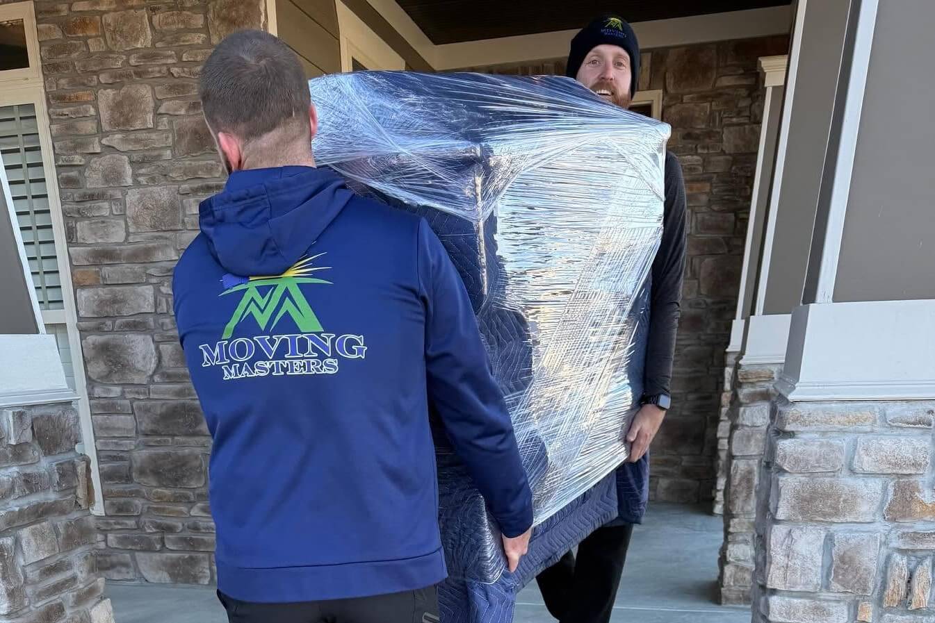 Movers relocating office furniture and equipment during a commercial move