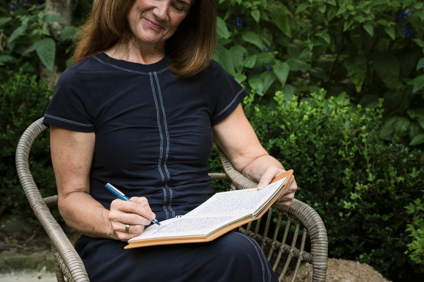 A woman journals outside.