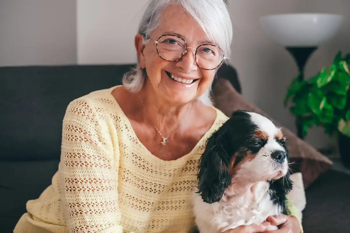 woman smiling with her dog