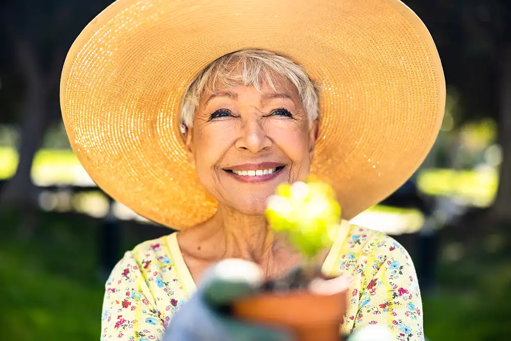 Woman in a wide brimmed hat with a flower