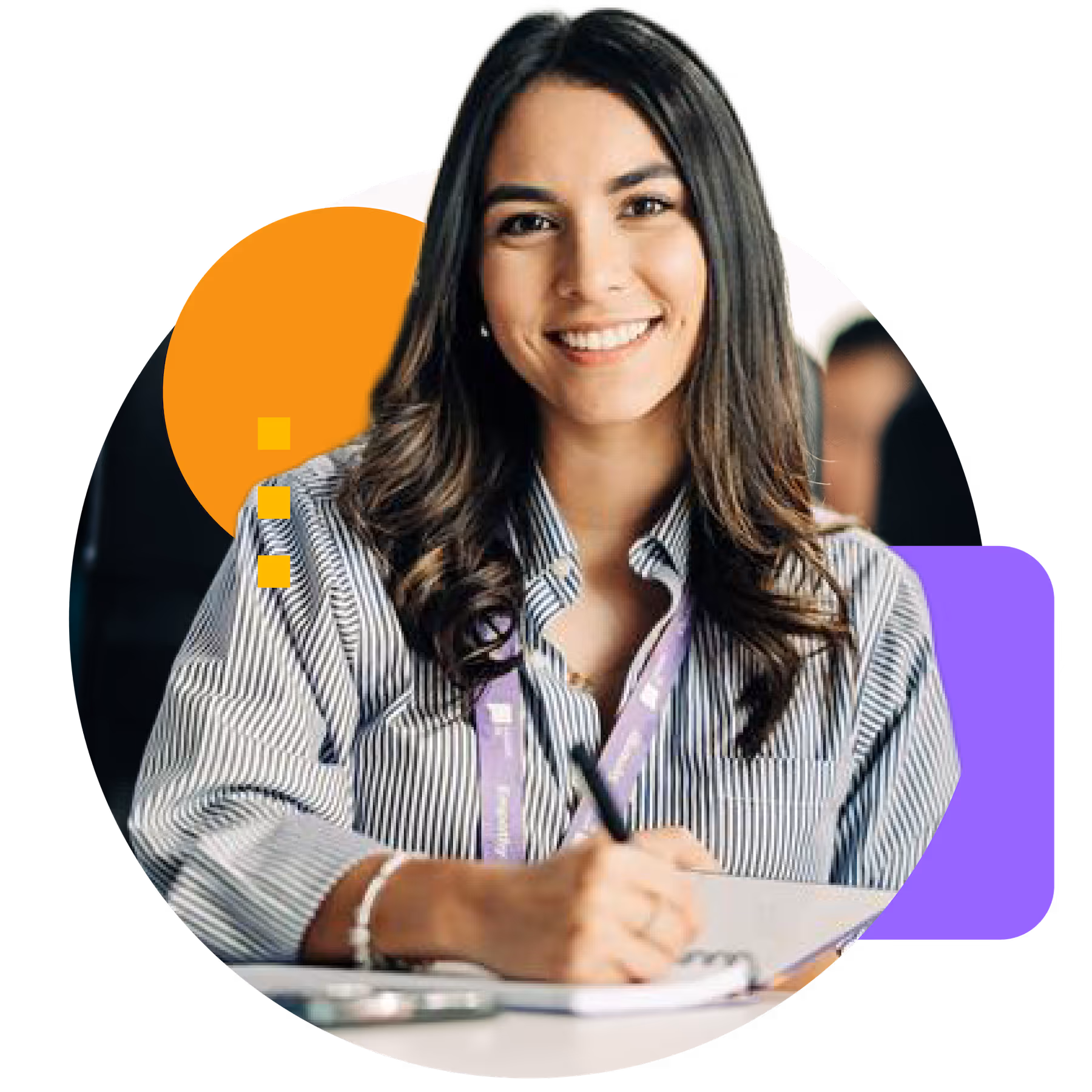 Smiling woman in a striped shirt writing in a notebook with a pen, wearing a purple lanyard.