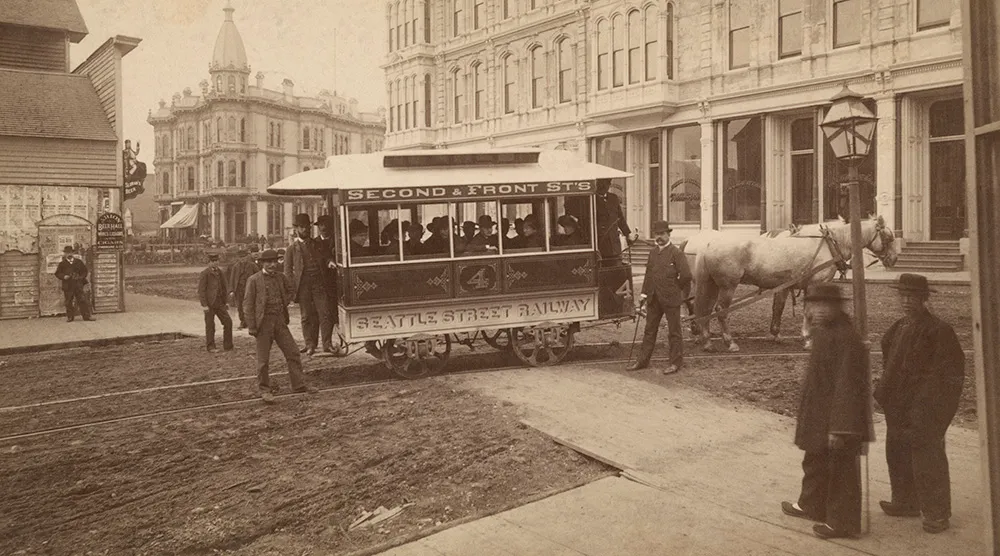 Horse-drawn Seattle Street Railway streetcar on opening day in 1884 at Mill Street and Second Avenue.