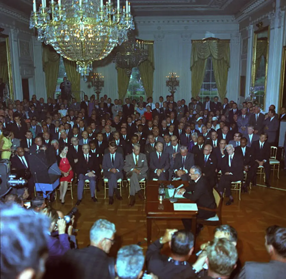 Lyndon Jonson signing the civil rights bill.