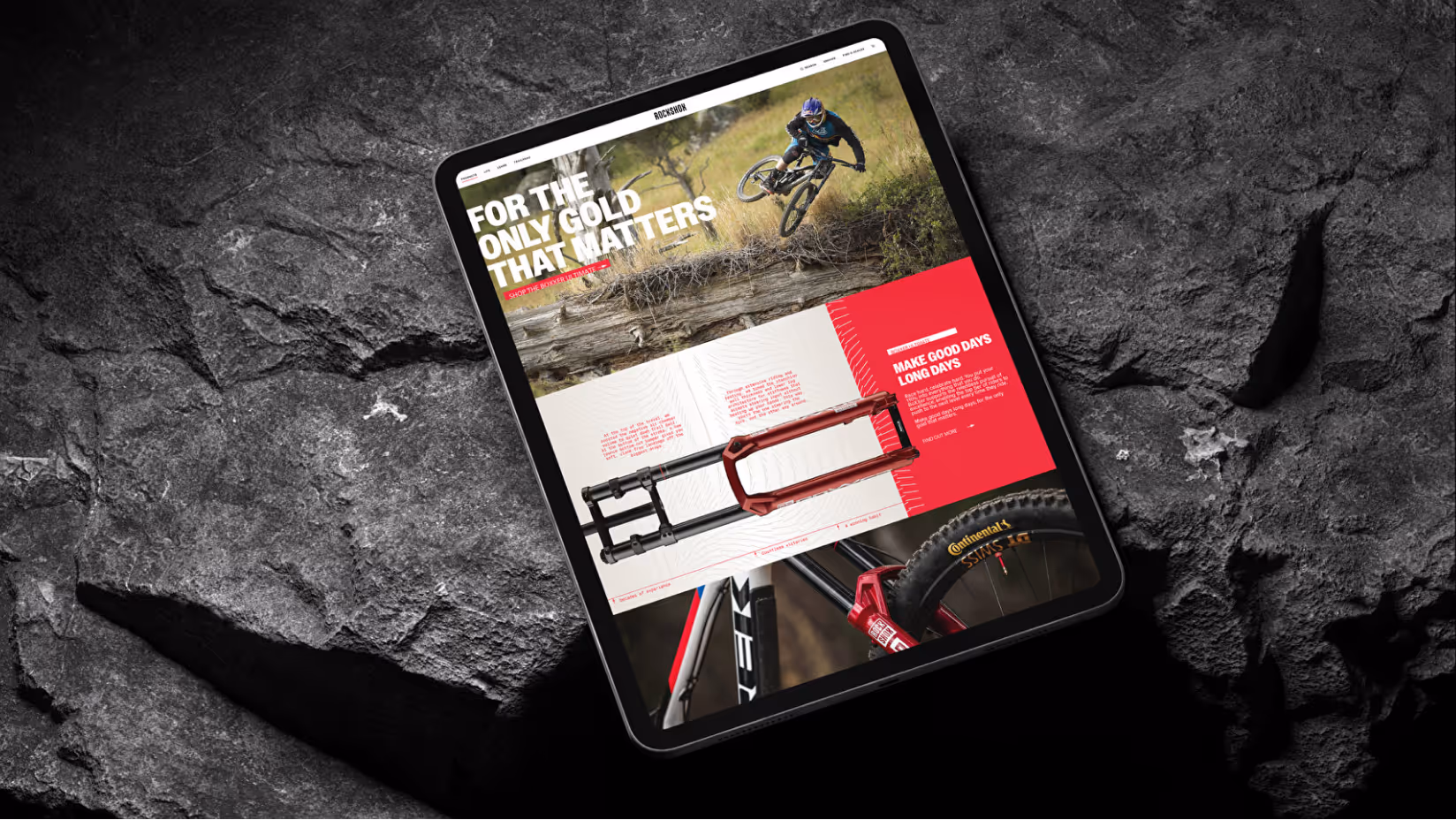 Tablet displaying a mockup of the RockShox website, featuring a mountain biker in mid-air and a red BoXXer suspension fork.