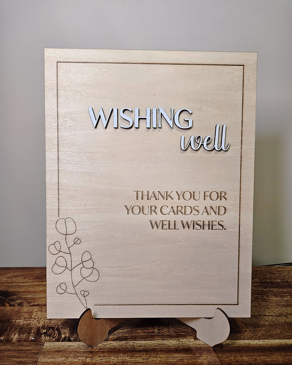 A wooden engraved wedding sign for a wishing well.
