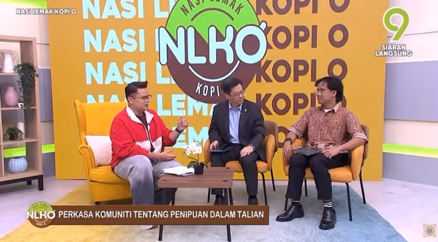 Three men seated in a studio with colorful Nasi Lemak Kopi O backdrop during a TV interview.