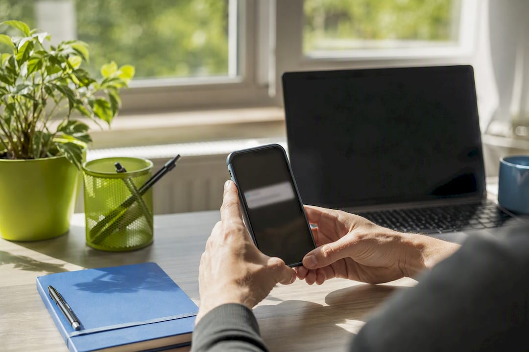 Hands holding smartphone with email alert