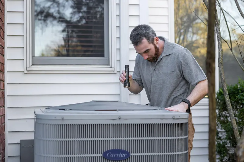 HVAC worker fixing a A/C unit.