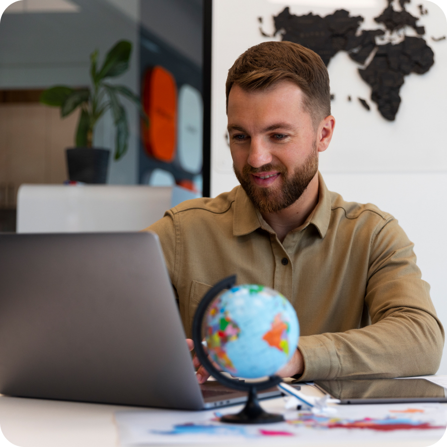 Man with laptop and globe