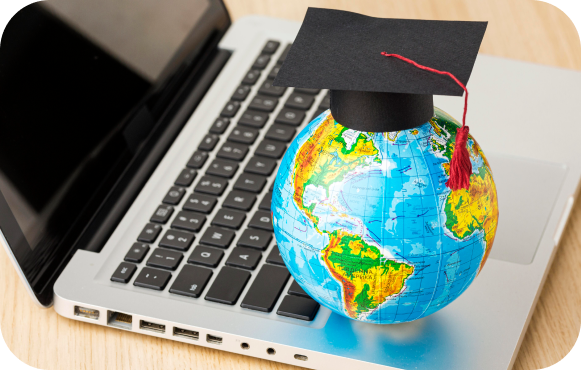 Laptop with globe and graduated hat