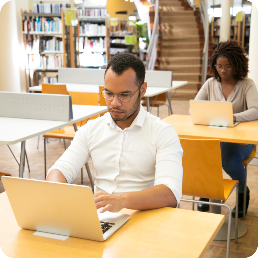 Library image with people working on laptop
