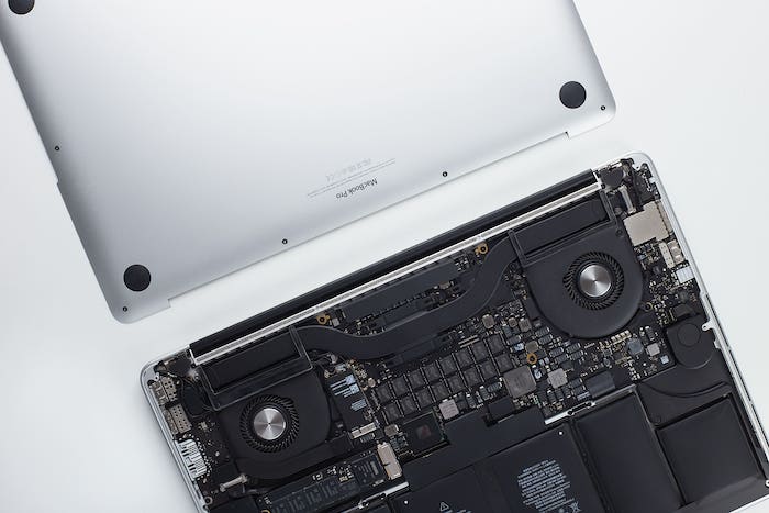 Laptop seen from the back and opened with all components visible.