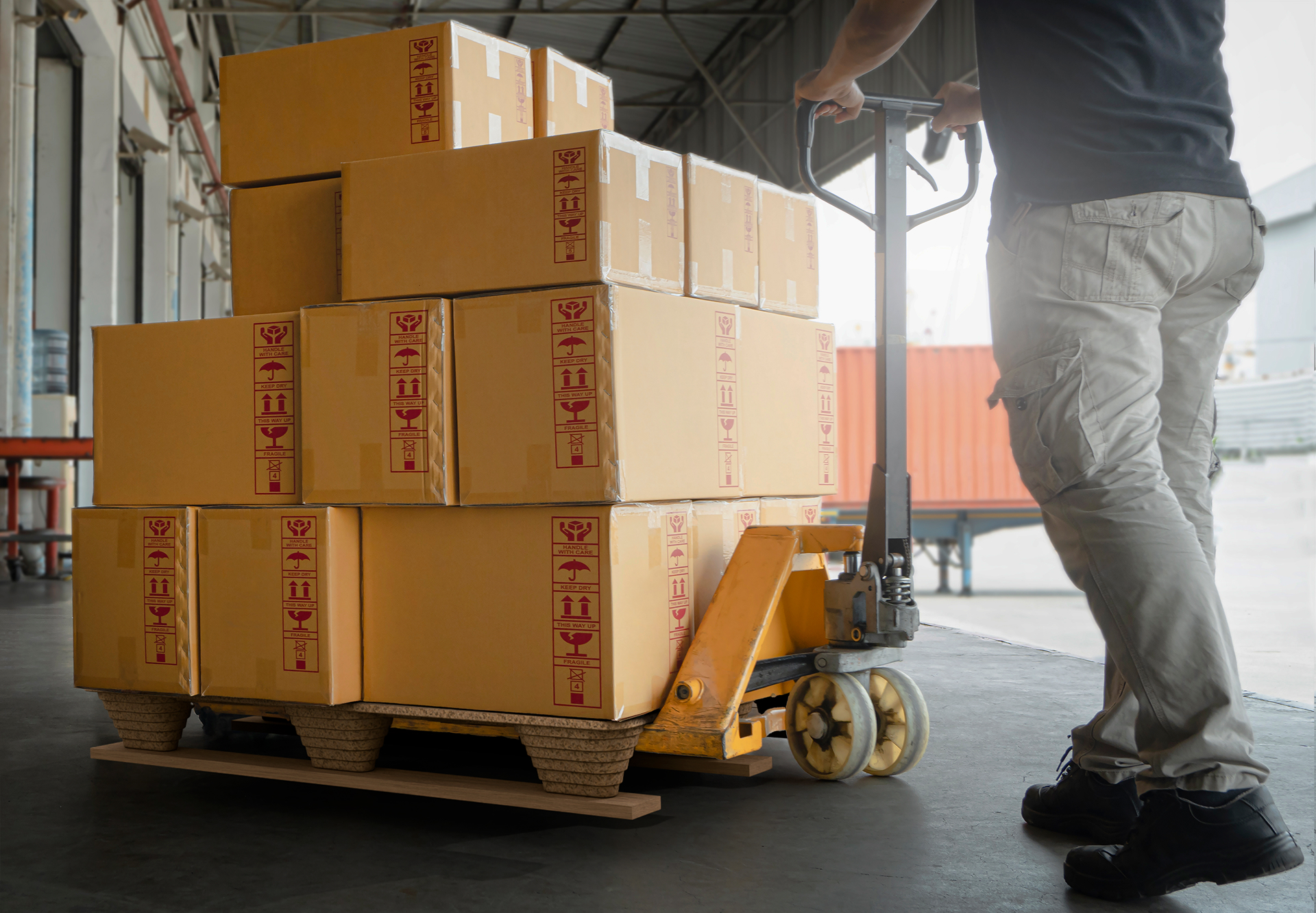 Hand touching TGR biobased pallet in warehouse