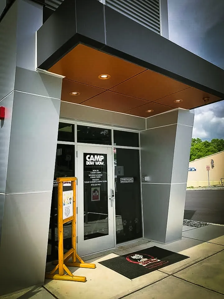 Commercial exterior with Camp Bow Wow signs, awnings, and shades entrance