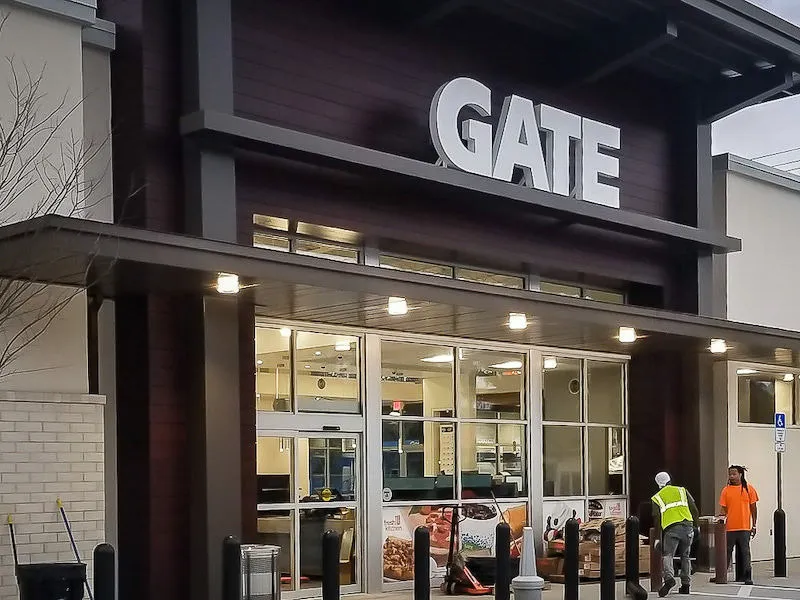 Commercial Gate building exterior with signs, awnings, and shades at entrance