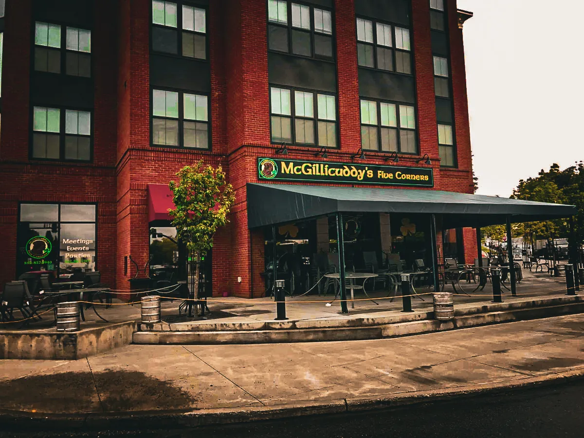 Commercial exterior with McGillicuddy's Five Corners, signs, awnings, and shades