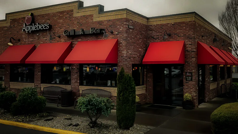 Commercial Exterior of Applebee's with Red Awnings, Signs, and Landscaped Entrance