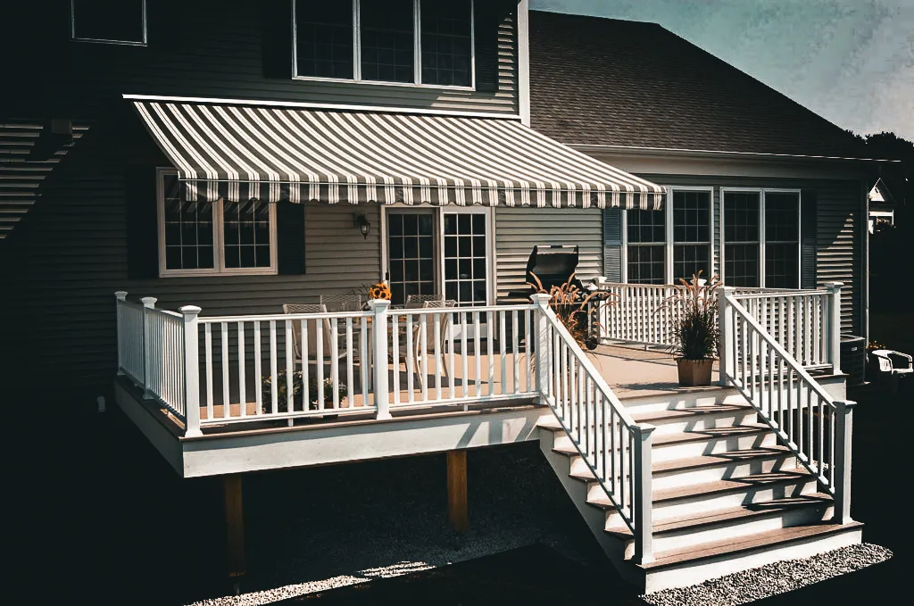 Commercial exterior with striped awnings, shades, and white deck signs