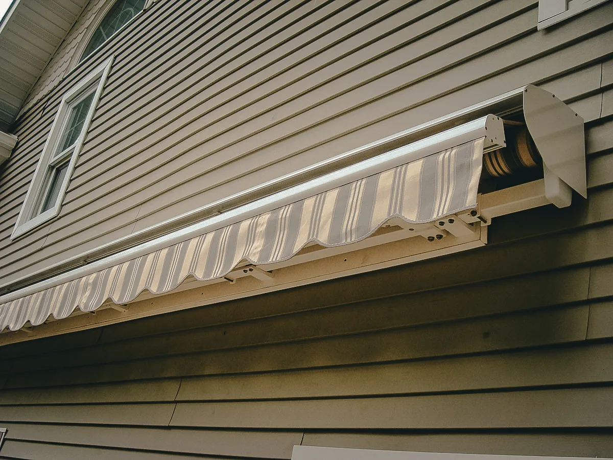 Commercial exterior window with retractable striped shade and awning