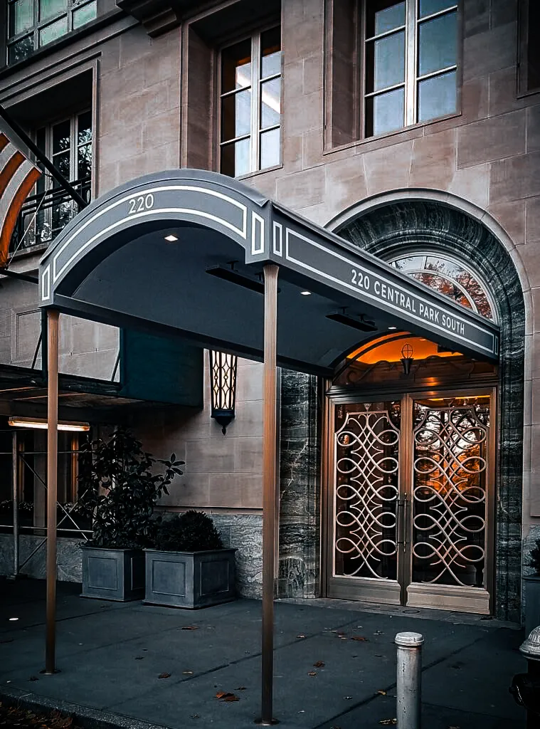 Commercial exterior with elegant awnings, signs, and ornate shades at 220 Central Park South