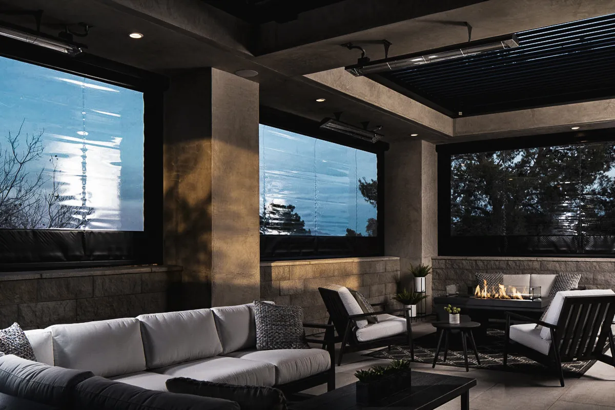 Commercial interior exterior lounge with shades, signs, and cozy fire pit