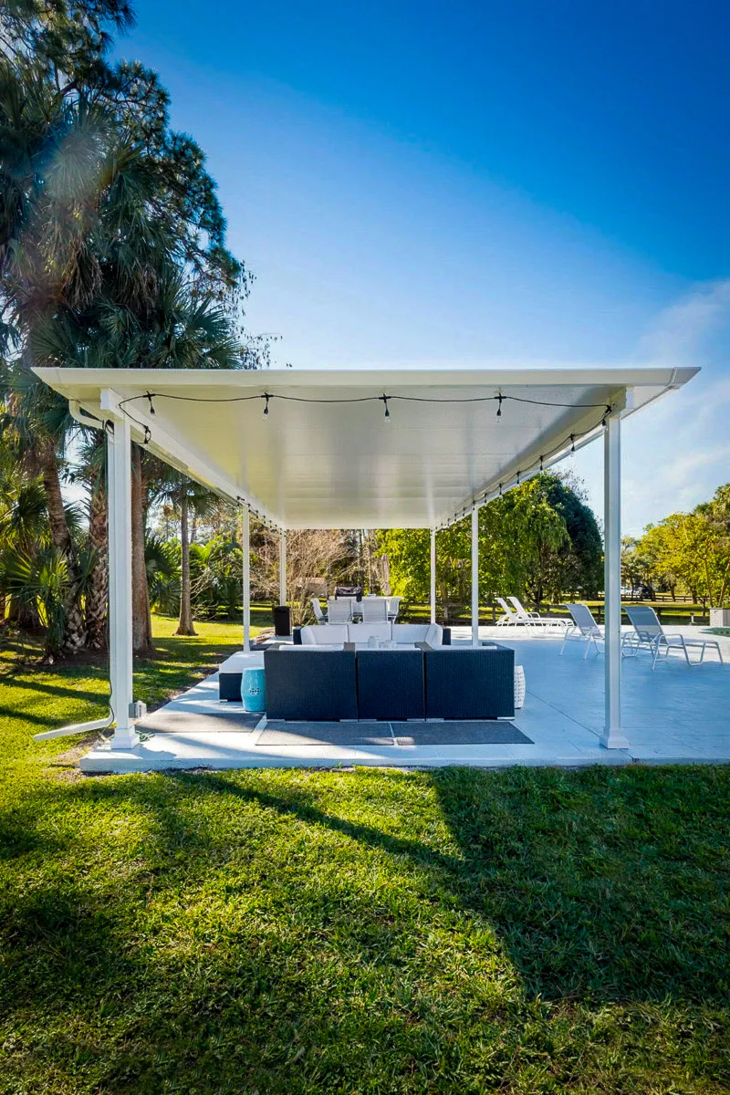 Commercial exterior shaded awning with seating area in tropical garden setting