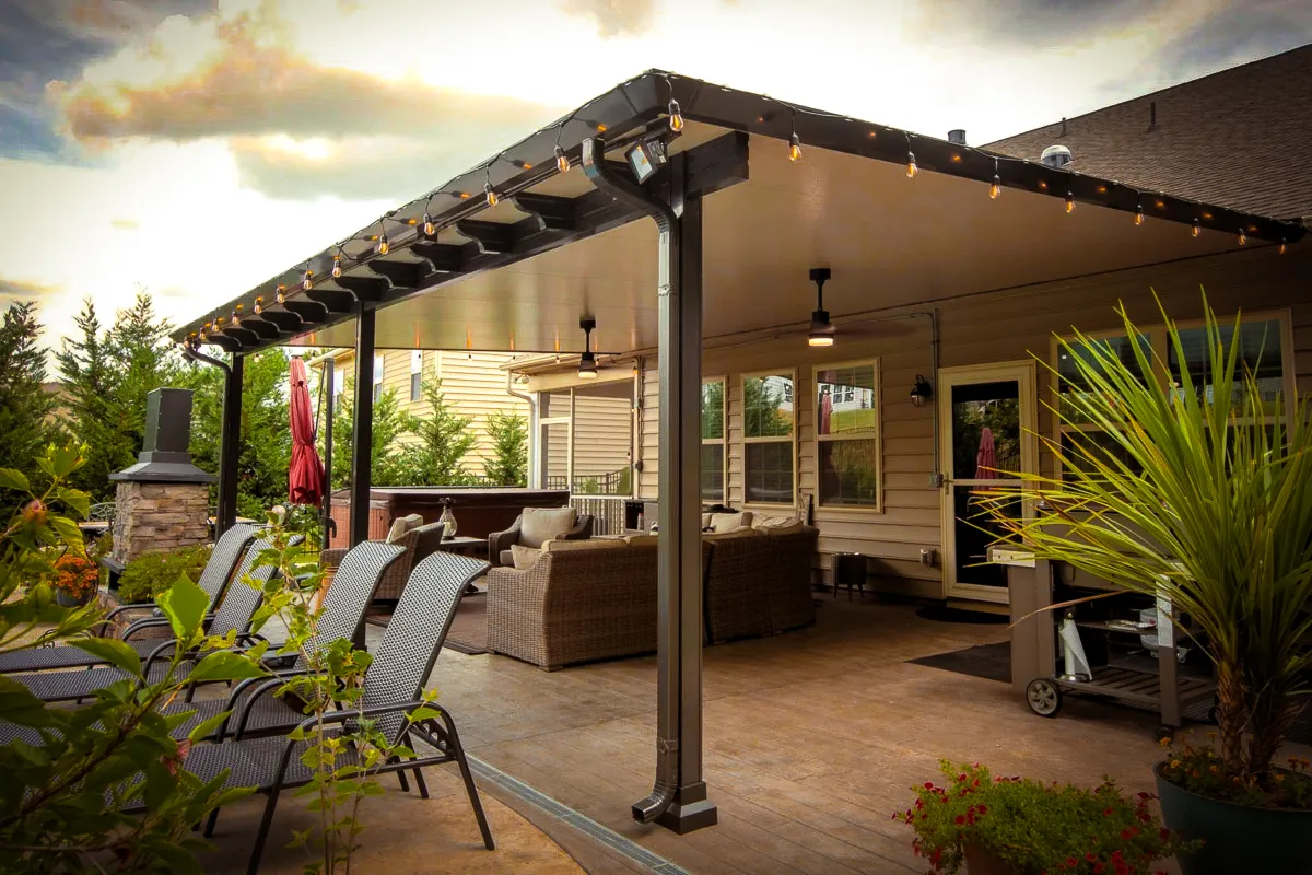 Commercial exterior patio with shades, awnings, and hanging string lights