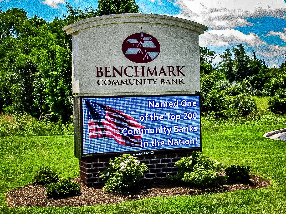 Commercial exterior sign for Benchmark Community Bank with digital display