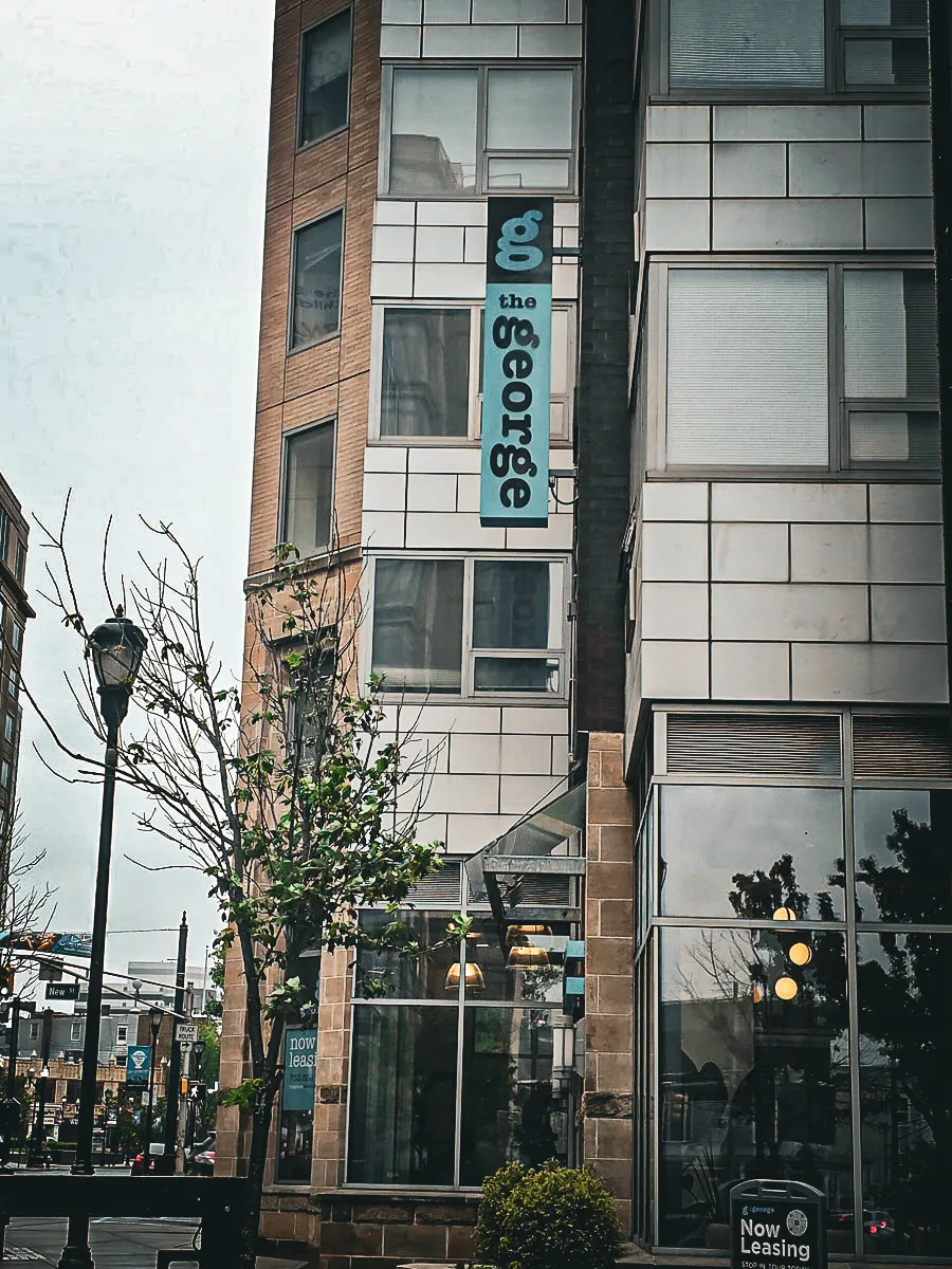 Commercial exterior with The George sign, awnings, and urban street scene