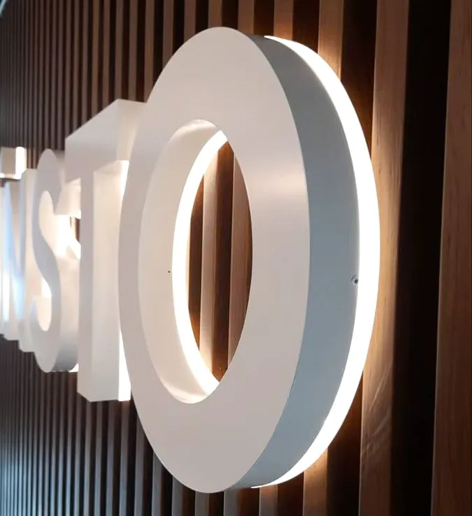 Commercial interior exterior sign with illuminated white O on wooden background