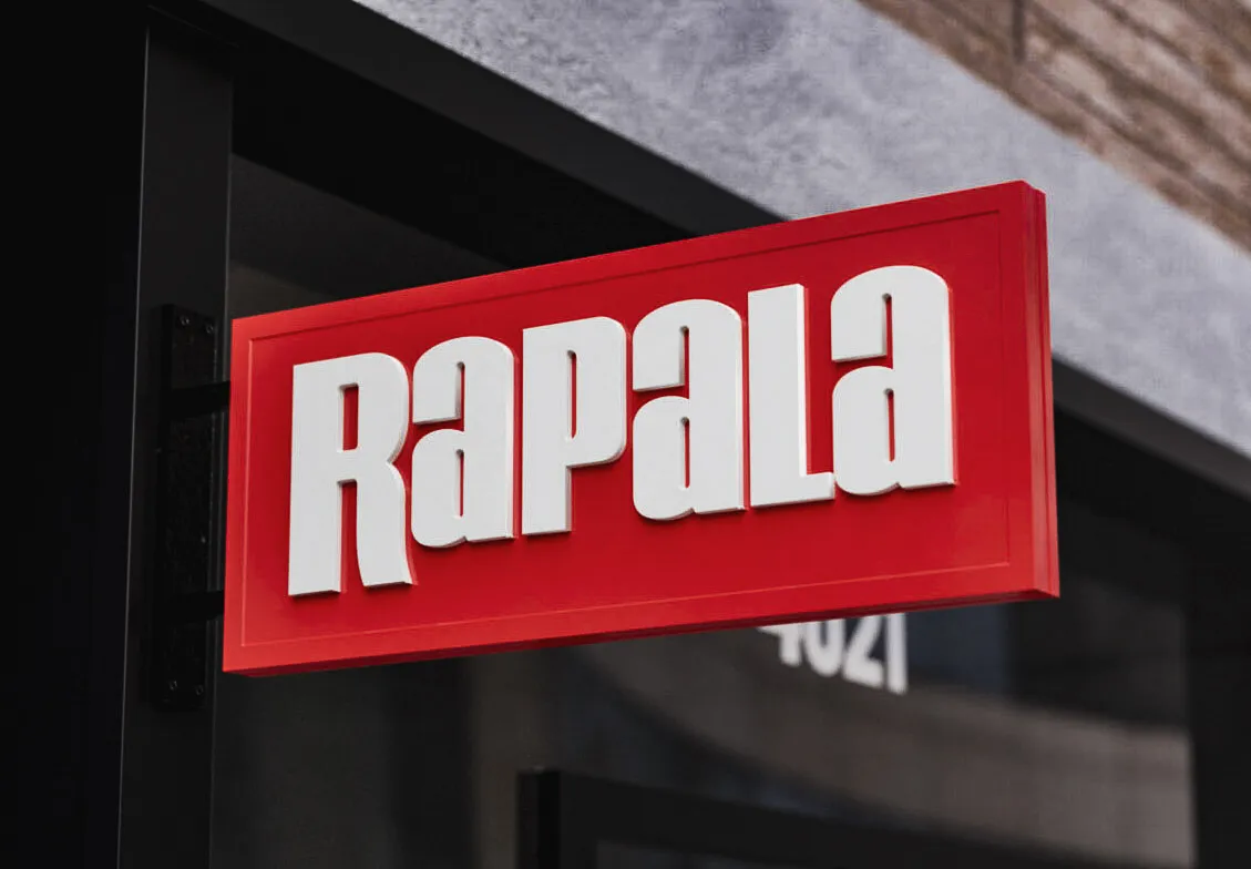 Commercial exterior signage with Rapala logo on red awning, hanging outside building