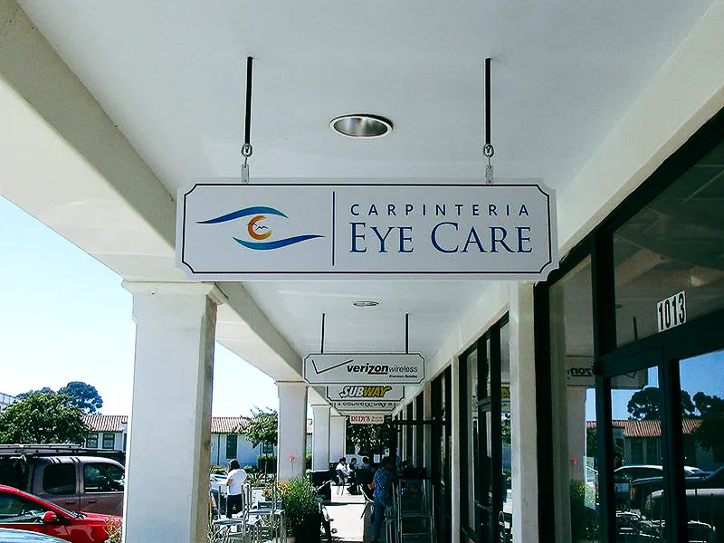 Commercial exterior with hanging signs, awnings for Carpinteria Eye Care