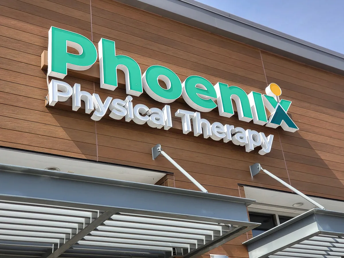 Commercial exterior of Phoenix Physical Therapy with signs, awnings, and shades