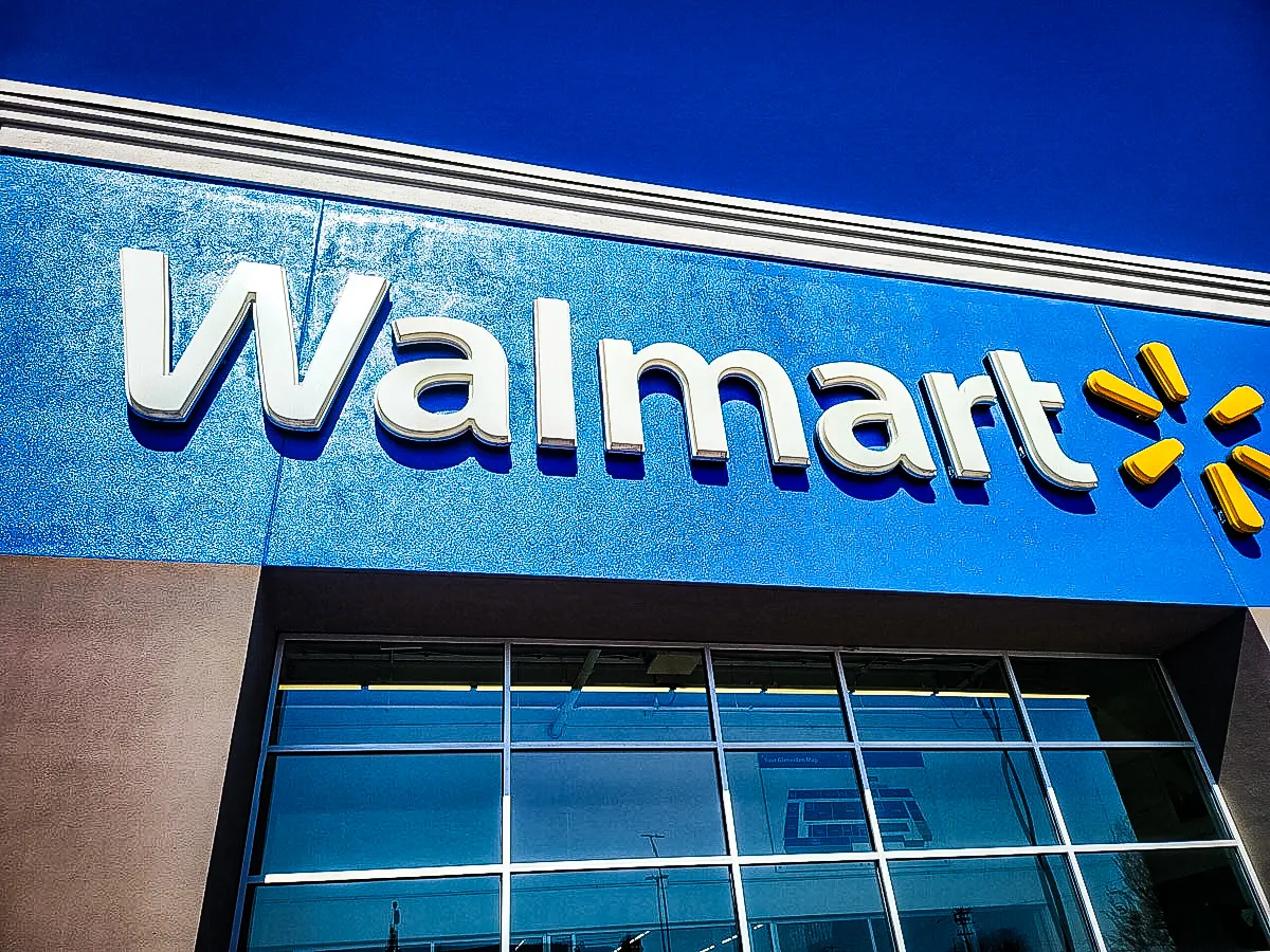 Commercial exterior with Walmart signs, awnings, and glass storefront