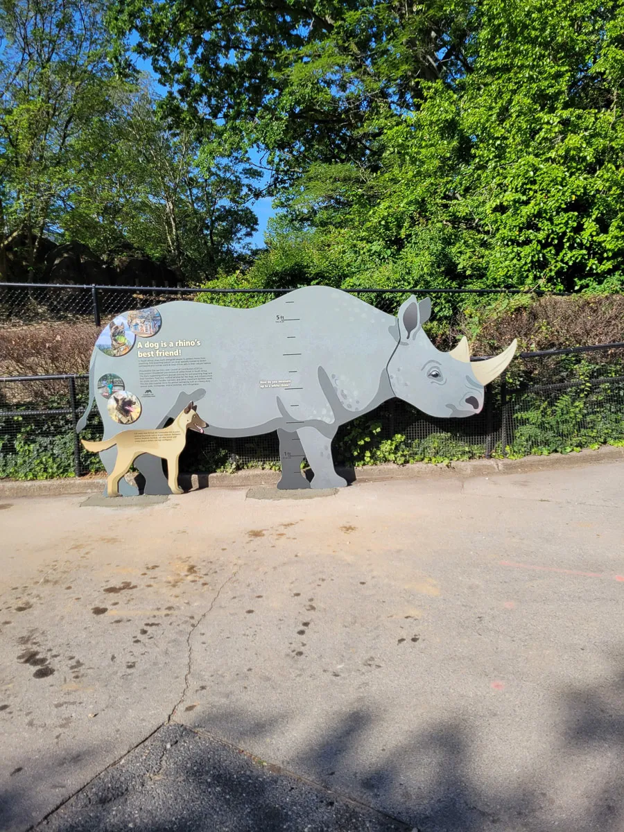Commercial exterior sign with informative rhino and dog display at zoo