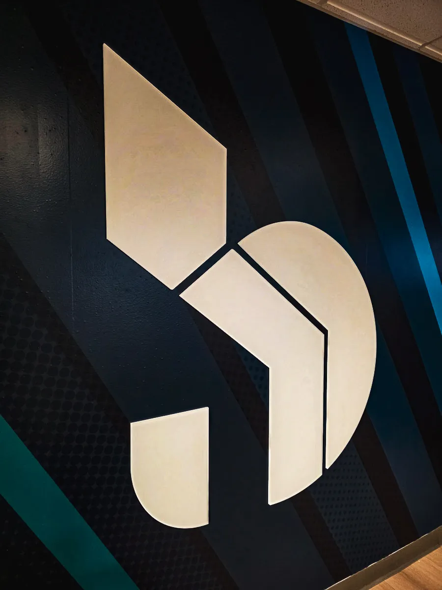 Commercial interior sign with modern geometric logo design on wall