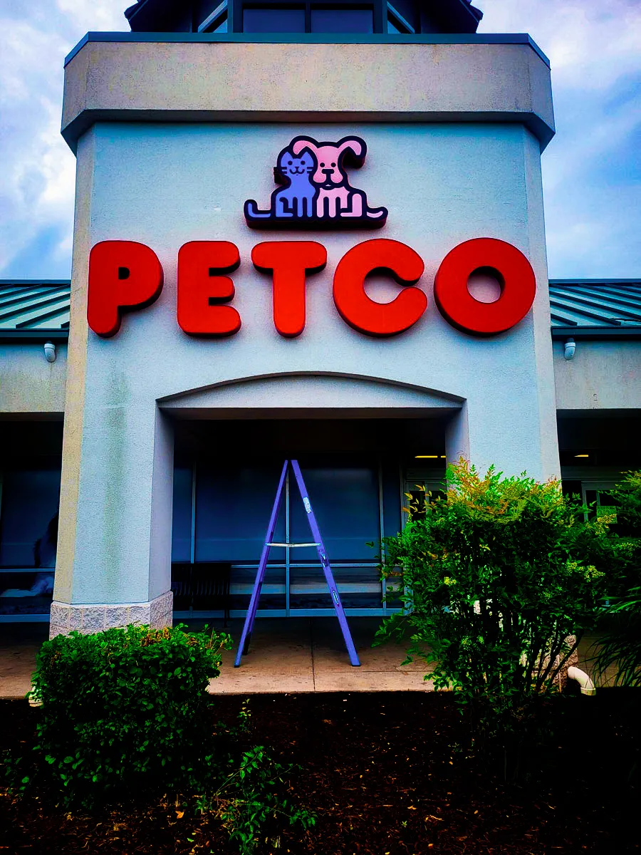 Commercial Petco exterior with large red signs, awnings, and pet logo