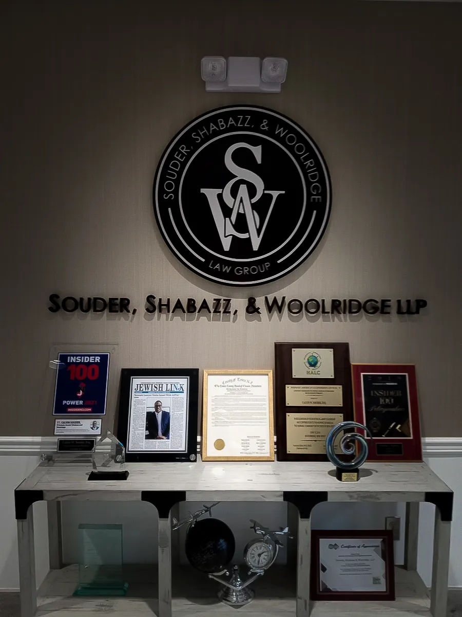 Commercial interior with law firm signs, awards, and exterior branding display