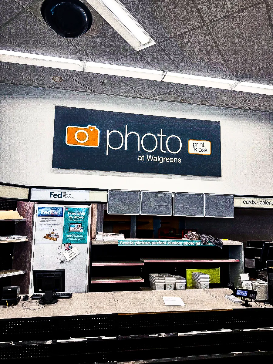 Commercial interior of Walgreens photo center with FedEx signs and awnings