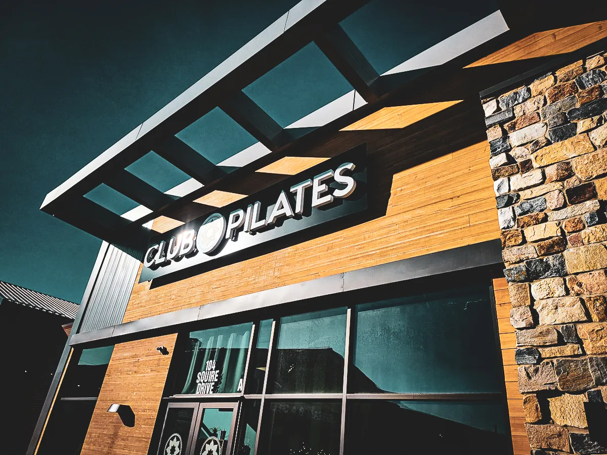 Commercial Exterior with Club Pilates Signs, Awnings, and Stone Shades