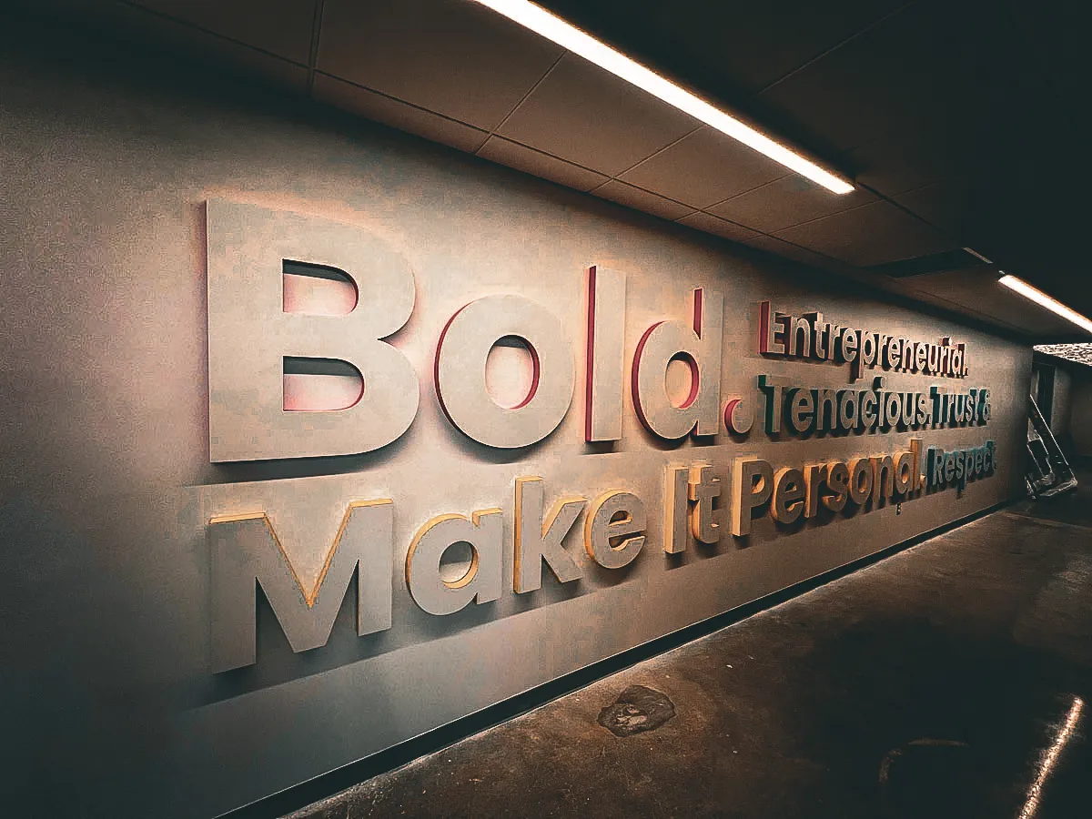 Commercial interior sign with bold motivational text about entrepreneurial trust